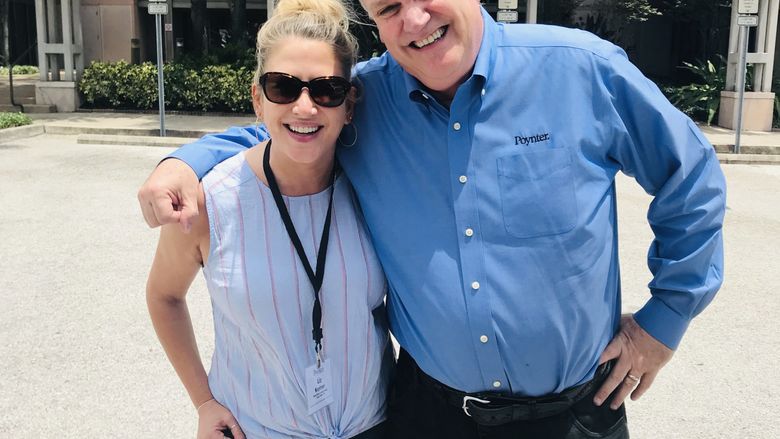 two people with arm around each other smiling