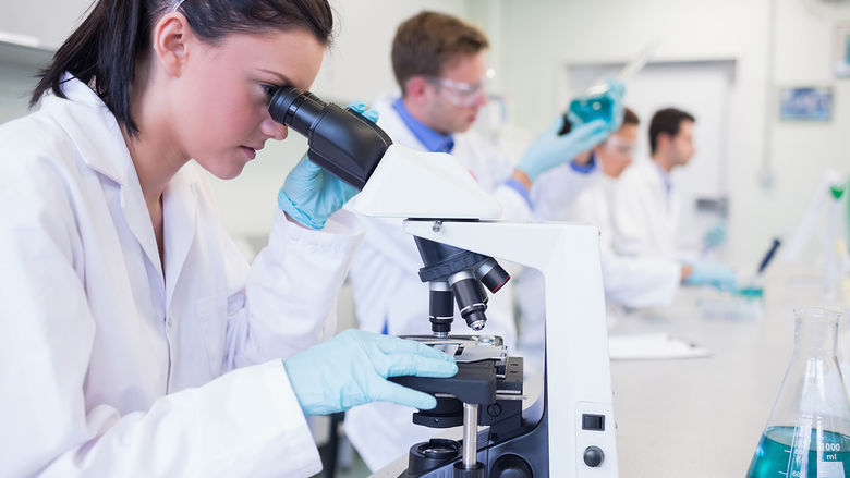scientists looking into microscopes