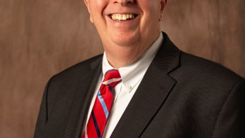 head shot of man with glasses and suit