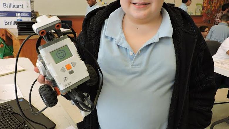 student holding robotic