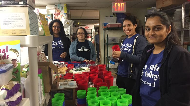 Group of volunteers stocking shelves