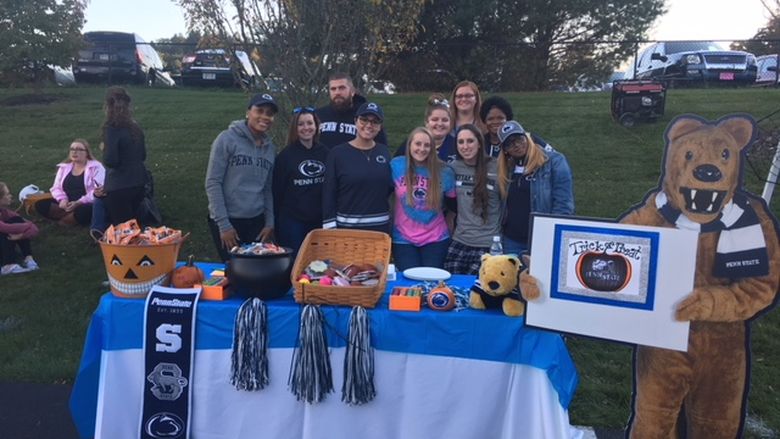 Group of students at PSU-LV table passing out items at Miracle League trick or treat