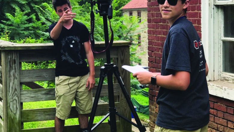 Young man setting up a camera for a shot