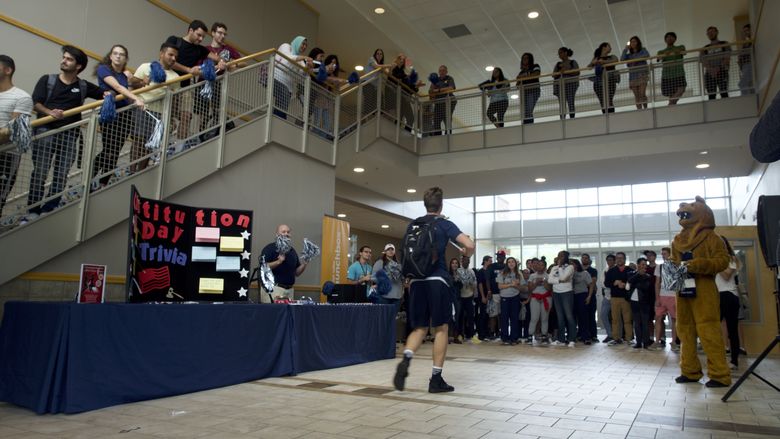 group of students gathering in Centre Hall with the Nittany Lion