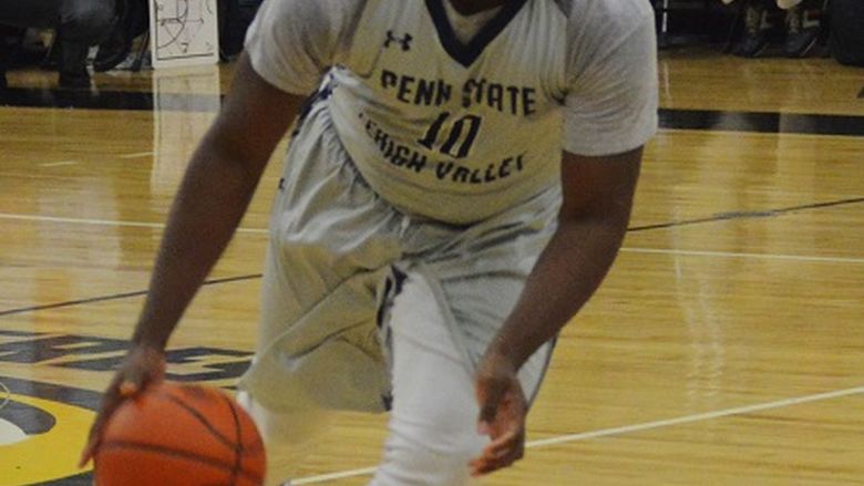 Othniel Nyamekye dribbling down the court.