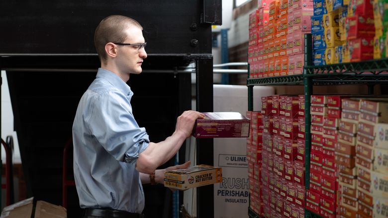 man stocking boxes on shelves