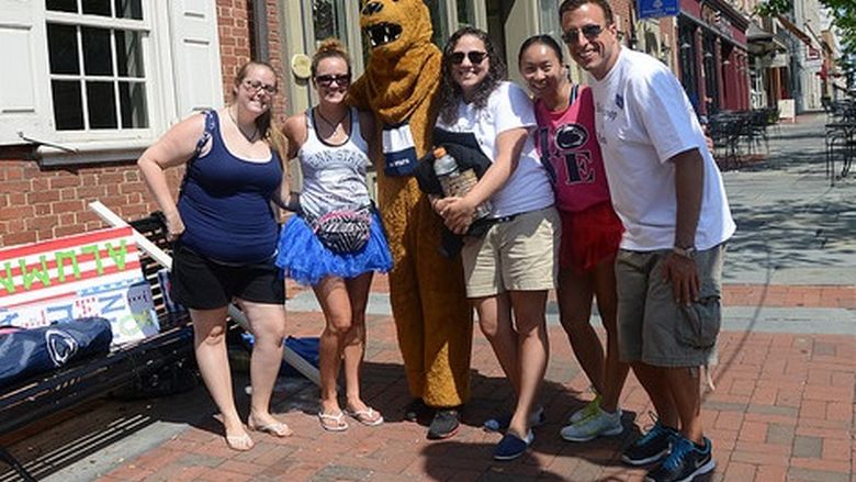Group of alumni and students with nittany lion