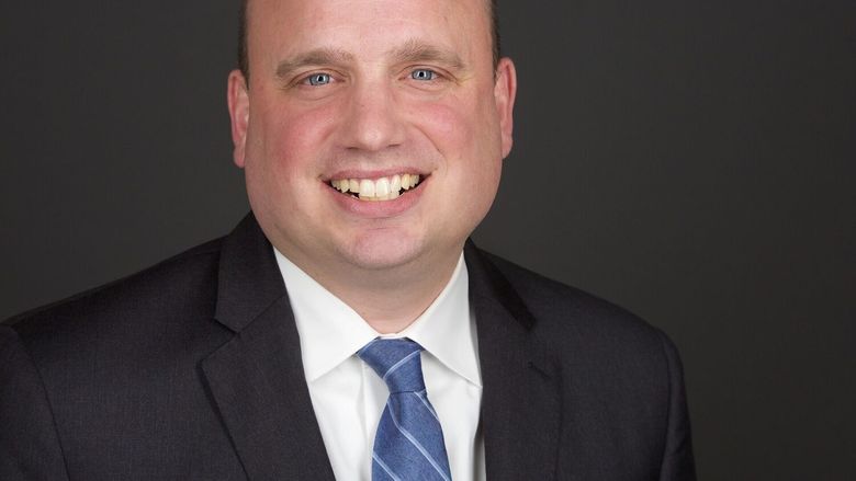 headshot of man in suit