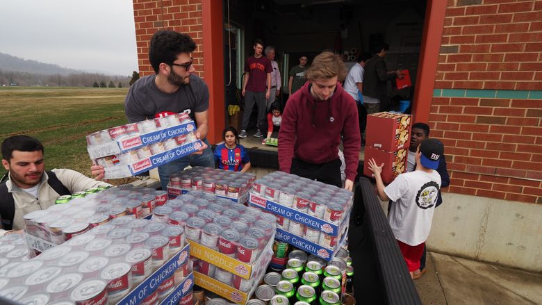 students unloading food donations off truck