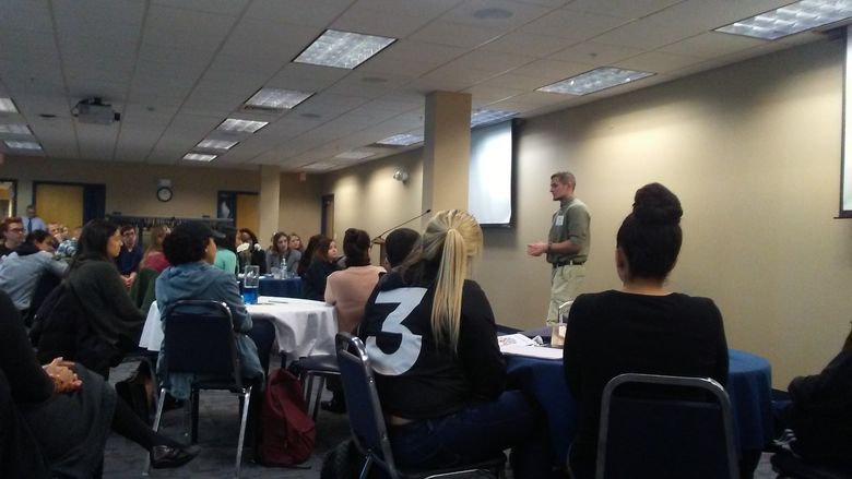 Man speaking to group of students