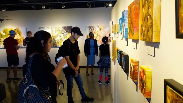 students viewing artwork on wall