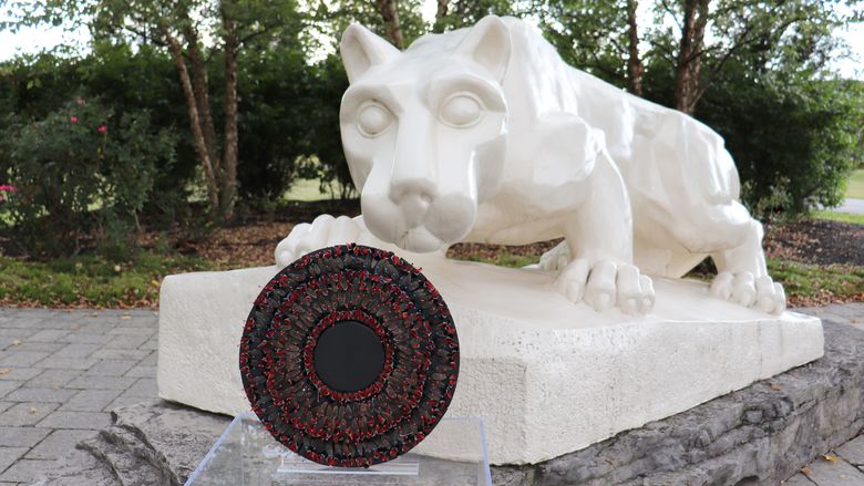 Nittany Lion Shrine with spotted lanterfly artwork in front of it