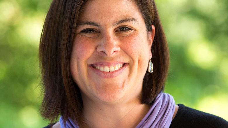 headshot of woman wearing purple scarf