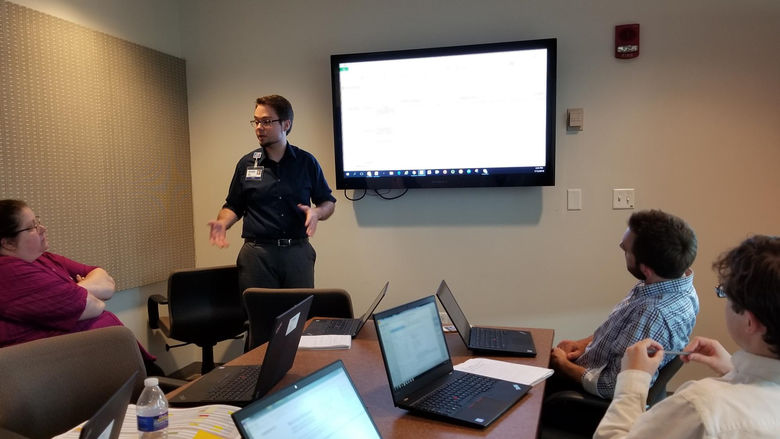 Male student giving a presentation for his internship
