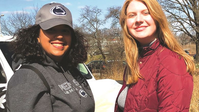 two students outside at a park