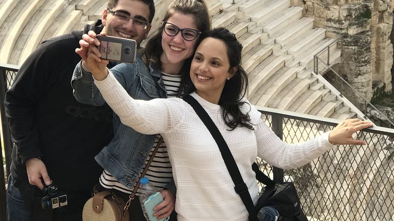 three students taking a selfie at the Acropolis