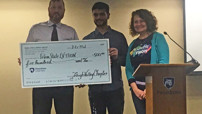 man presents big check