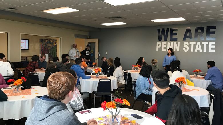 students eating around tables