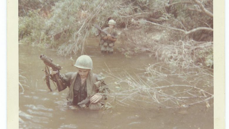 Tom Roney crossing a river