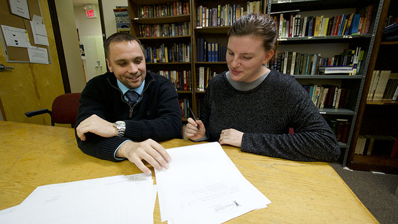 man and young woman meeting in a library