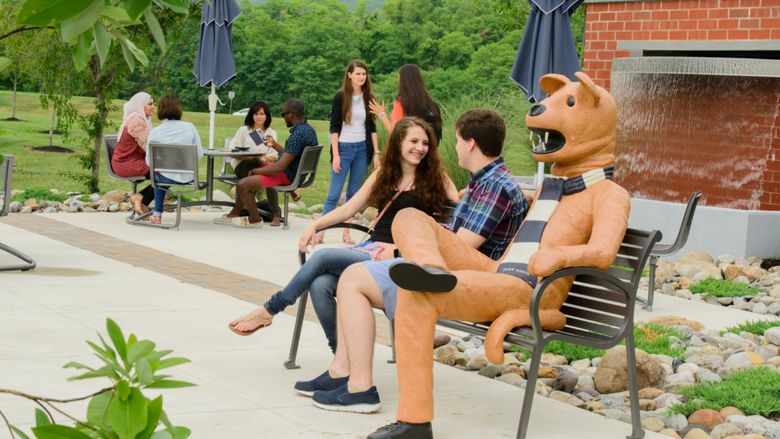 Students by Nittany Lion bench at Student Plaza