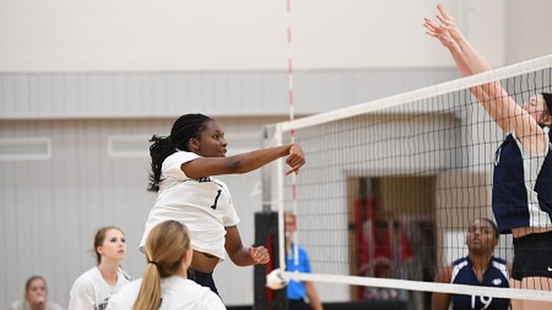 women's volleyball team hitting the ball over the net
