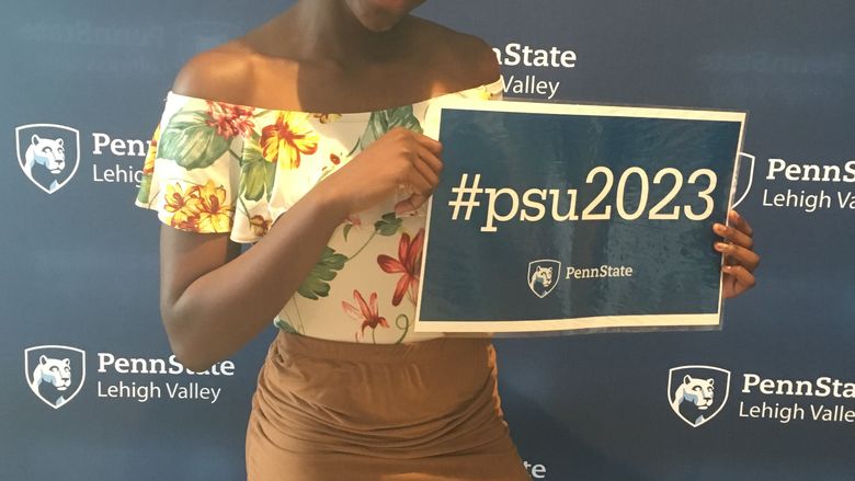 young woman holding a psu2023 