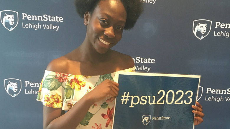 young student holding sign with #psu2023