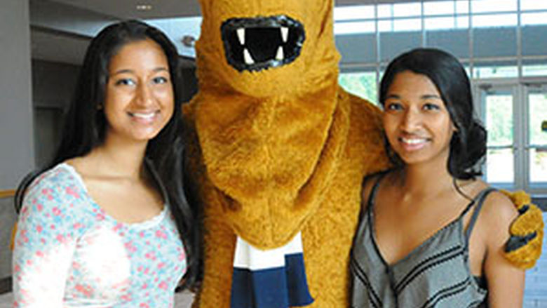 Two students and nittany lion