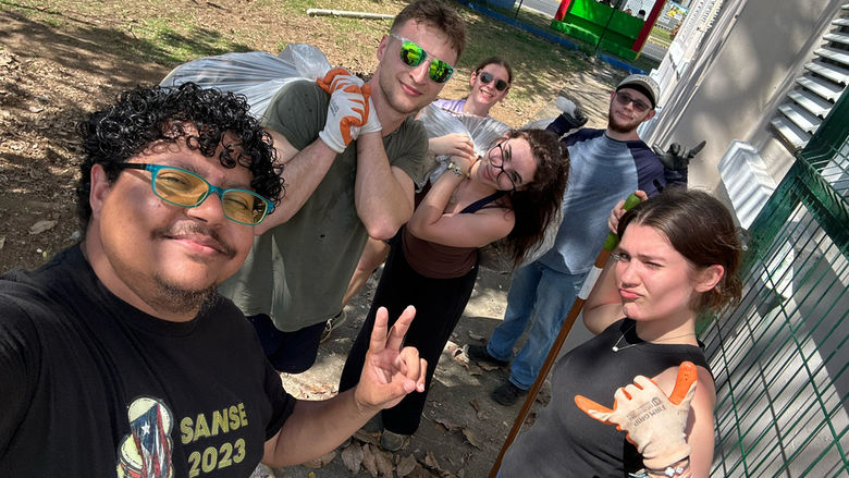A group of students pause from clean-up efforts to pose for the camera
