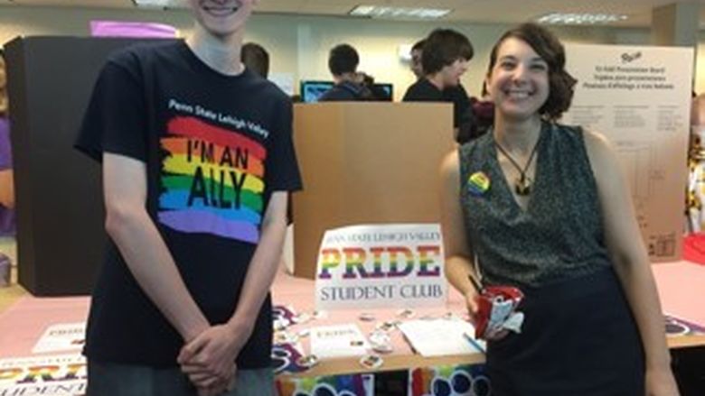 two  people at a station at an activities fair