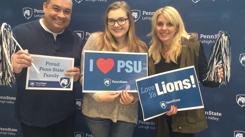 Family posting with PSU signs