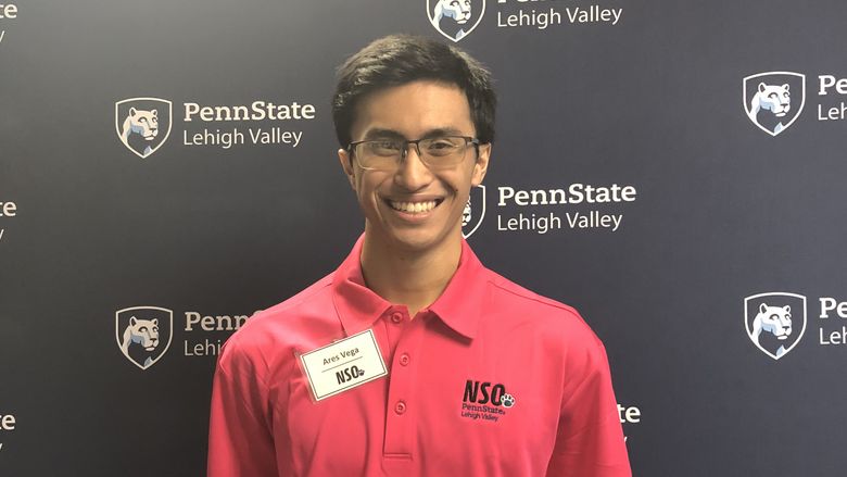 Young man standing in front of Penn State Lehigh Valley backdrop