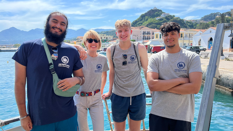 students smile in front of the Agean Sea in Greece 