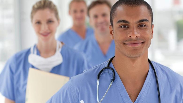 four nurses smiling 
