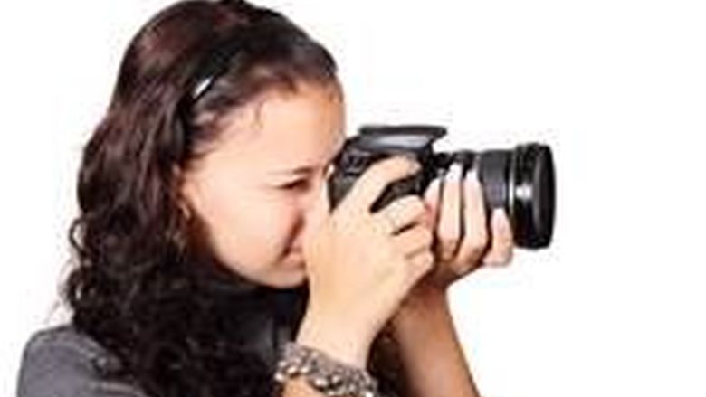 girl holding a camera to her face