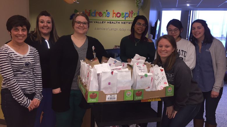 staff and students while presenting donated bags to LVHN