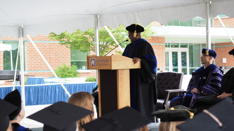 woman in academic dress at podium