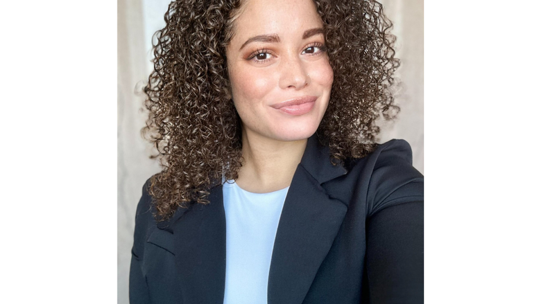 a headshot of a woman in a blazer smiling 