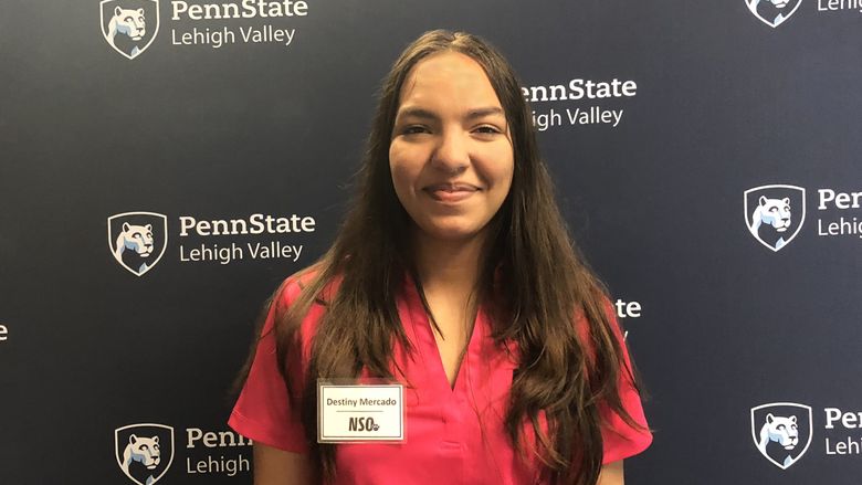 Young woman standing in front of Penn State Lehigh Valley backdrop