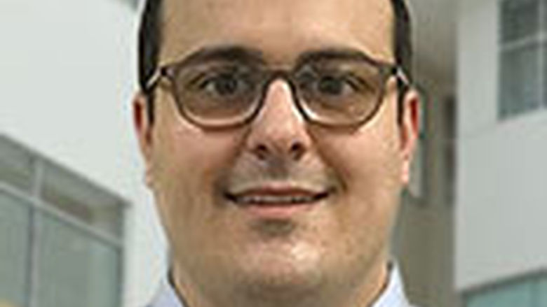 head shot young man wearing glasses in shirt and tie