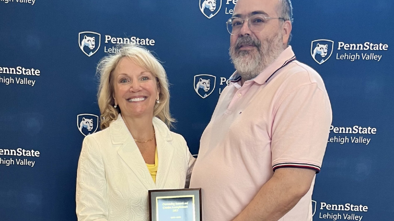 A photo of Nichola D. Gutgold, ph.d receiving her research reward at the annual All Campus Day event.