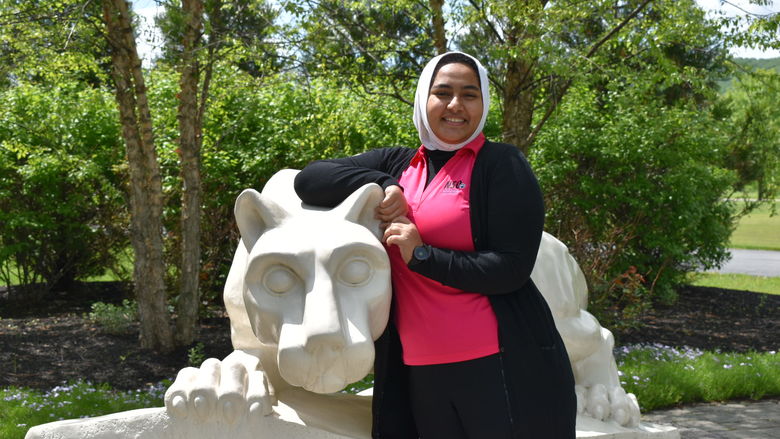 girl standing at Nittany Lion Shrine