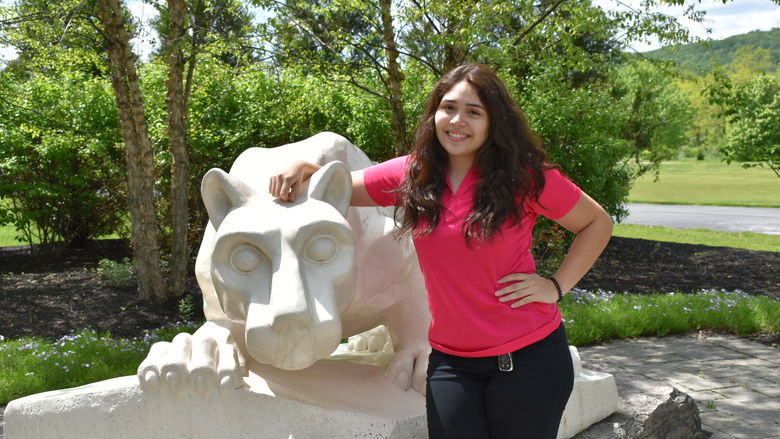 girl standing at Nittany Lion Shrine