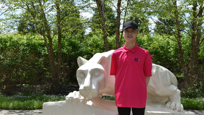 boy standing at Nittany Lion Shrine