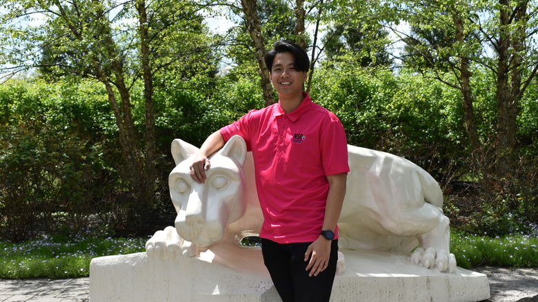 boy standing at Nittany Lion Shrine