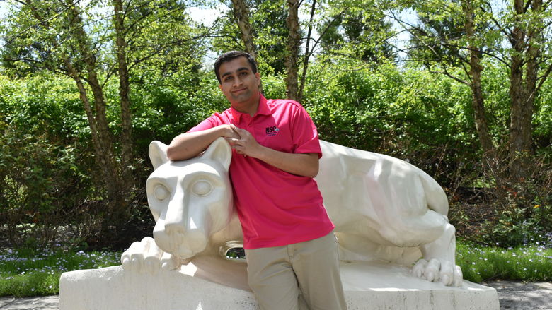 boy standing at Nittany Lion Shrine