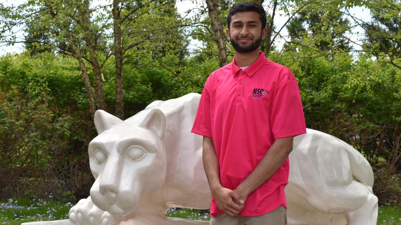 boy standing at Nittany Lion Shrine