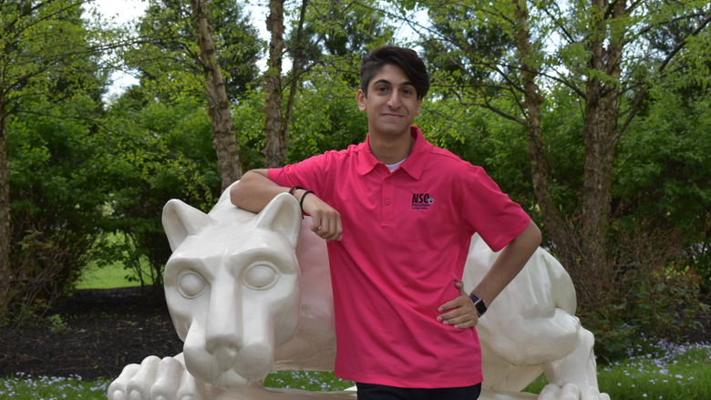 boy standing at Nittany Lion Shrine