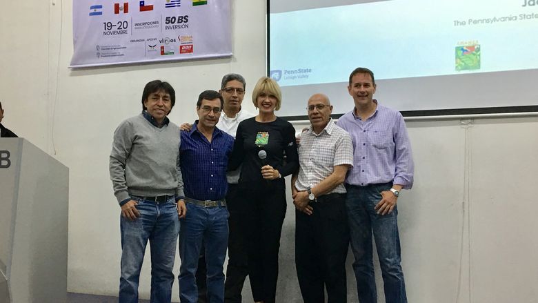 Dr. Jacqueline McLaughlin in the center with people from Bolivia at a presentation